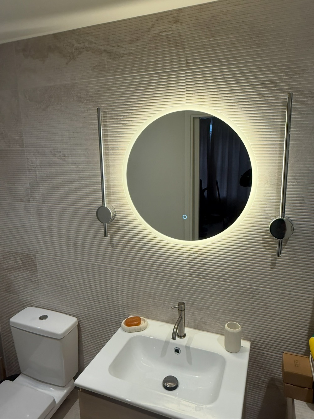 Bathroom vanity with round backlit mirror