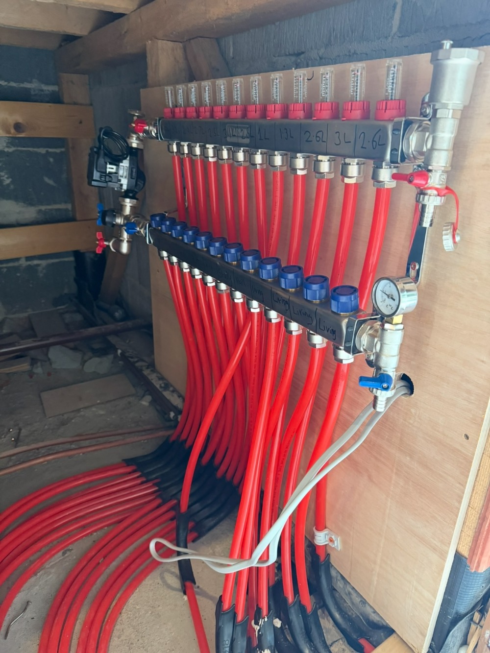 Underfloor heating manifold installed on a wall